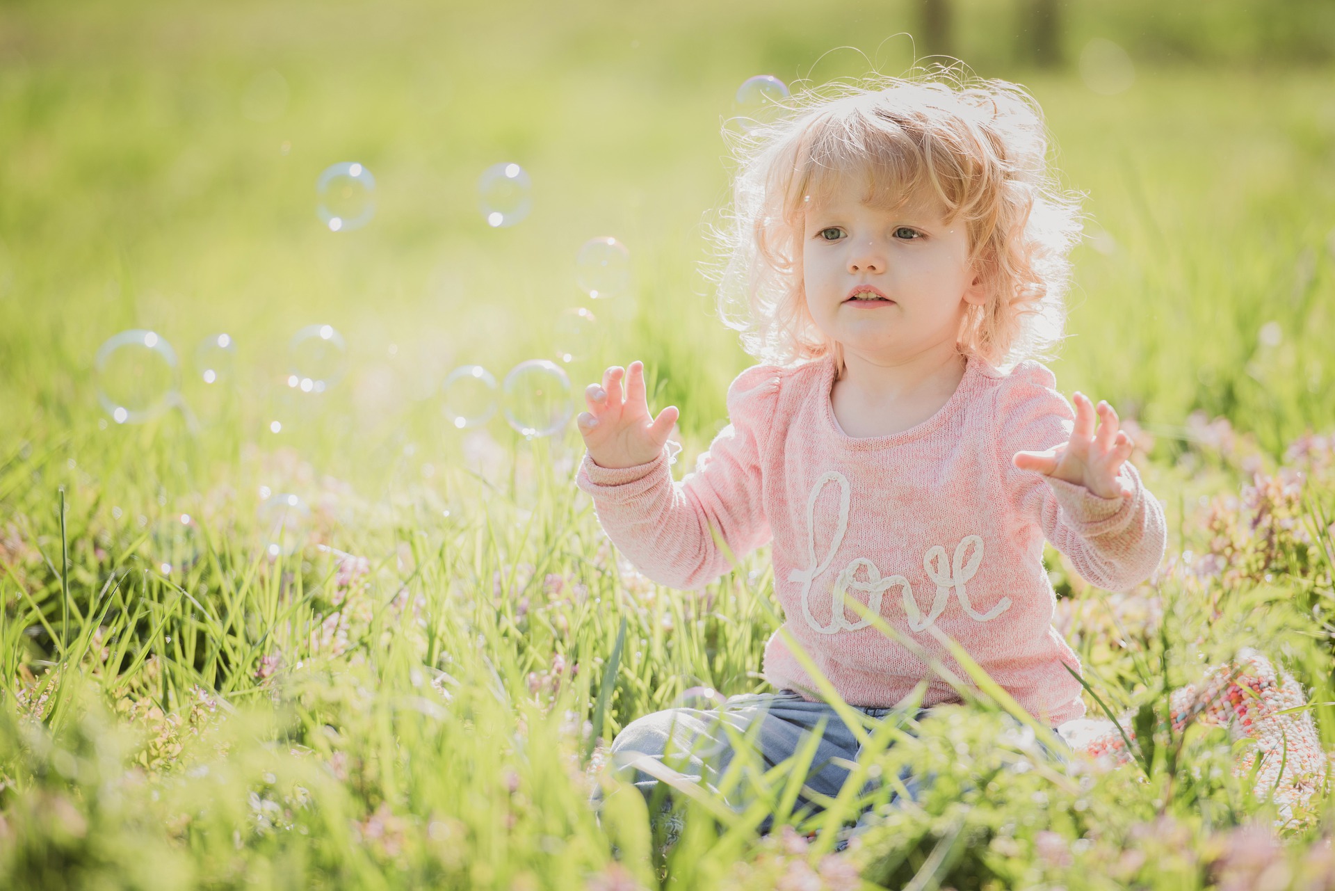 child sat in a meadow