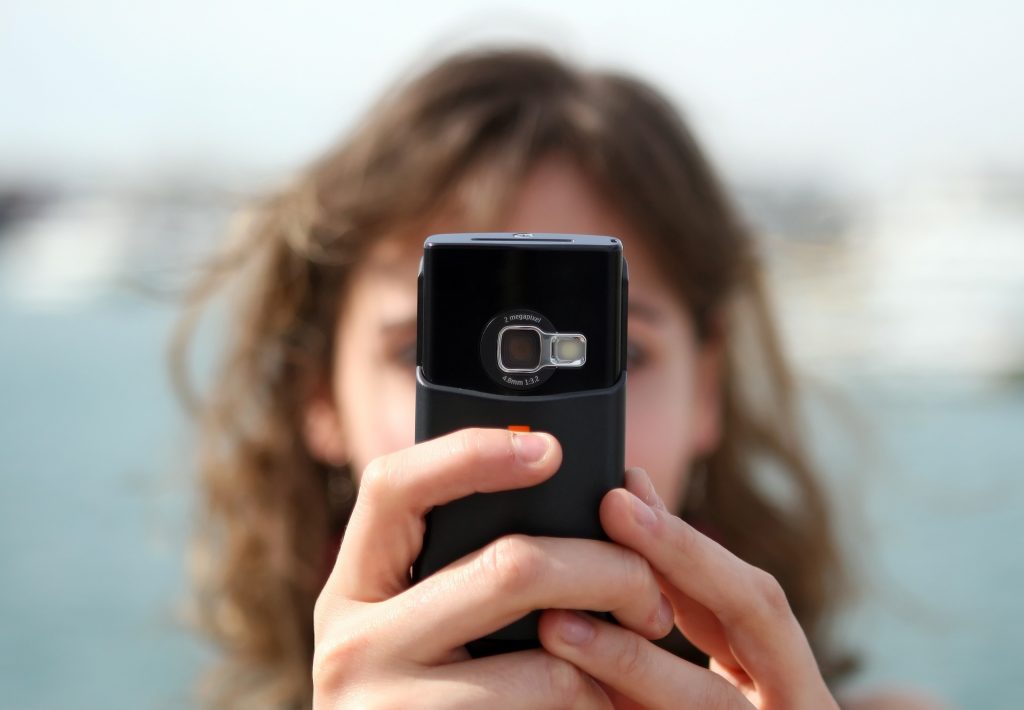 lady with phone filming